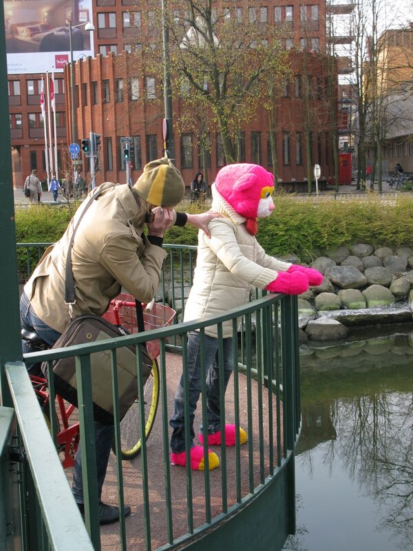 Under the Rainbow, bear-headed figure on the bridge